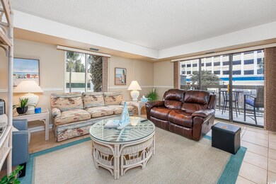Living room with a textured ceiling and light tile