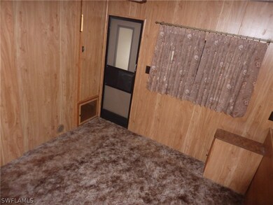 Bedroom with door going into utility room