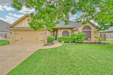 View of front of house with concrete driveway, an