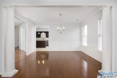 The Dining Room features formal columns and hardwood floors