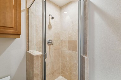 Bathroom featuring walk in shower and toilet