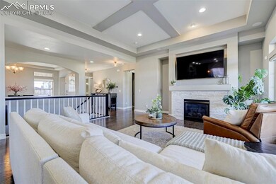 Living room with a fireplace, dark hardwood / wood