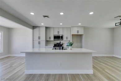 Kitchen featuring baseboards, visible vents, stain