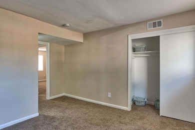 Unfurnished bedroom with carpet, a closet, and a t