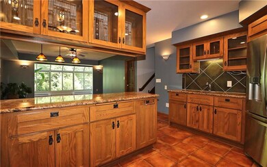 Beyond the refrigerator is a wet bar with the seco