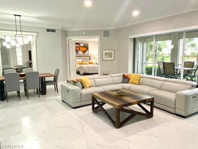 Living room with crown molding and a chandelier