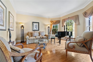 The elegant parlor exudes timeless charm, featuring refined architectural details and a graceful atmosphere perfect for receiving guests or enjoying quiet moments