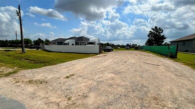 View of  the property with a gravel driveway, ampl