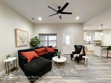 Living room featuring sink, light hardwood / wood-