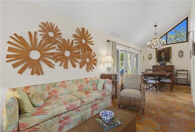 Living area with french doors, high vaulted ceiling, and a chandelier