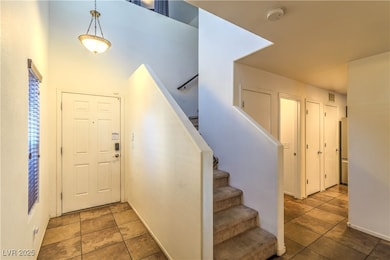 Entryway featuring stairs and tile patterned flooring