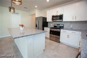 Kitchen featuring appliances with stainless steel