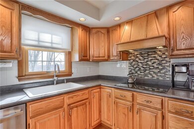 The chef's kitchen features endless counter space, with a complimenting backsplash,  for meal prep and clean up.