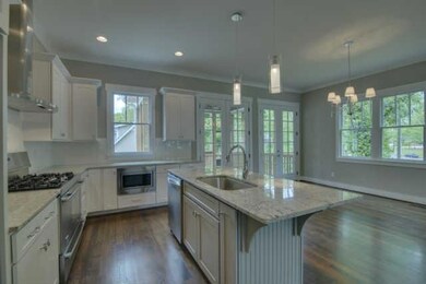 French doors in dining room lead to a  large screened in porch. This open floor plan is perfect for entertaining!