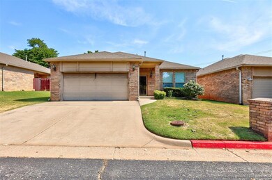 Ranch-style house featuring a front yard and a gar