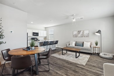 Dining space featuring dark wood-type flooring, b