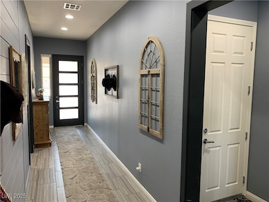 Foyer featuring recessed lighting and baseboards