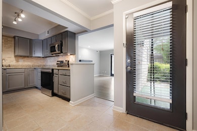 Kitchen with stainless steel appliances, backsplas