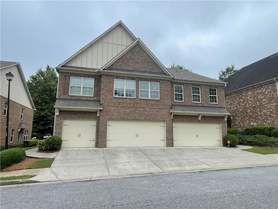 Craftsman house featuring board and batten siding, brick siding, driveway, and an attached garage