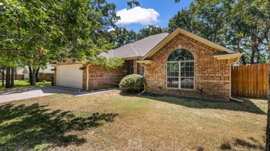 View of front of house with a garage and a front lawn