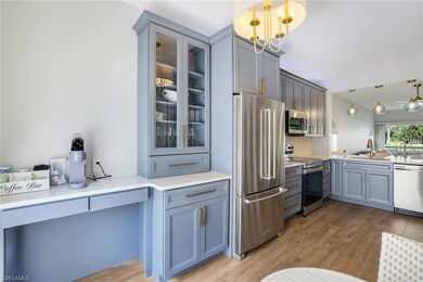 Kitchen featuring gray cabinets, a sink, appliance