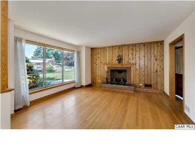 Large sunny living room with wood burning fireplac