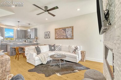 Living room with ceiling fan, light wood-type floo