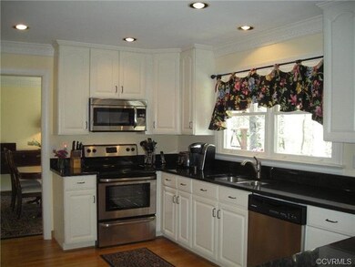 Kitchen is spacious with granite countertops, ss a
