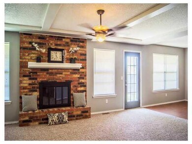 Living Room. Beautiful fireplace in this large ope