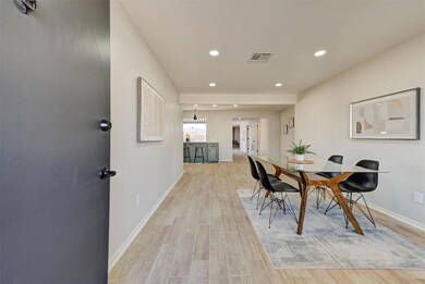 Dining room with light wood look tile, this room c