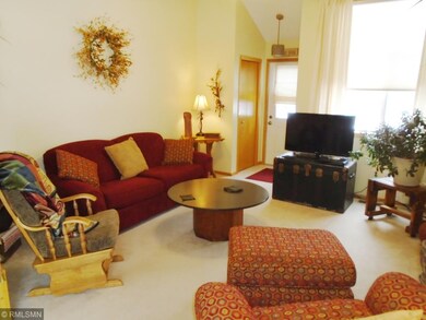 Attractive living room with soaring vaulted ceilin