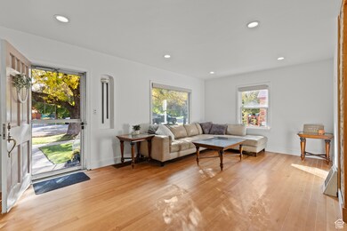 Living room with light wood-style floors and recessed lighting