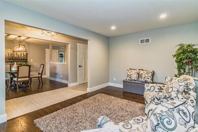 Open foyer with a living room and dining room on e