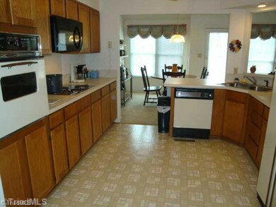 Kitchen. Kitchen with pantry and appliances to remain,  Window  opening into Living Room view