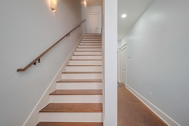 This photo shows a clean and bright hallway with w