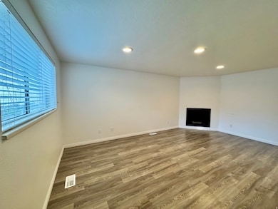 Unfurnished living room with a fireplace, light wood-type flooring, and recessed lighting
