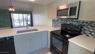 Kitchen featuring a sink, black range with electri