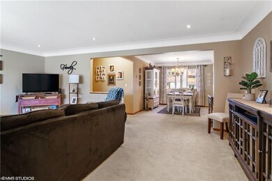 Spacious front room freshly painted with carpet. Hardwood under the carpet.
