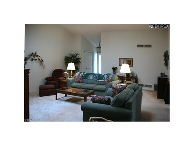 This spacious, vaulted Great Room greets you on en