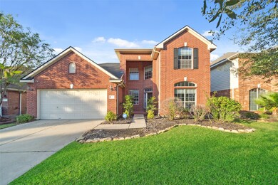 This is a two-story, brick-facade home featuring a