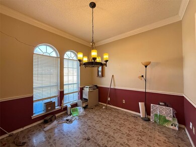 Dining space with a textured ceiling, ornamental m