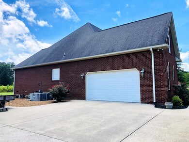 2-car attached garage with concrete parking & driveway.