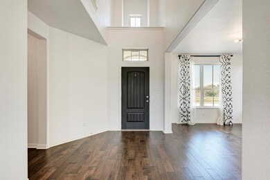 Entryway with baseboards and wood finished floors
