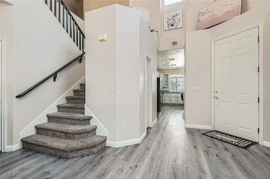 Entryway featuring wood finished floors, stairs, a