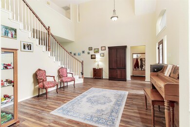 Living room leads to the primary suite, utility room and garage!