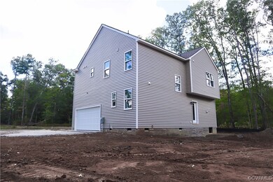 View of side of property with a garage