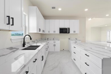 Kitchen featuring a sink, stainless steel microwa