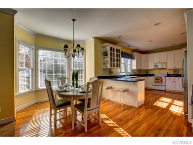 Eat in Kitchen with bay window. Wood flooring look