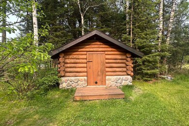 View of shed featuring a wooded view