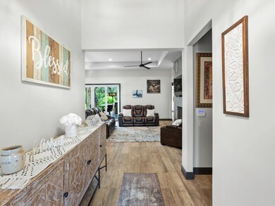 Hall featuring wood finished floors and recessed 